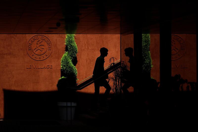 A person enters a building during the first round matches of the French Open tennis tournament at the Roland Garros stadium in Paris, France. Alessandra Tarantino / AP Photo
