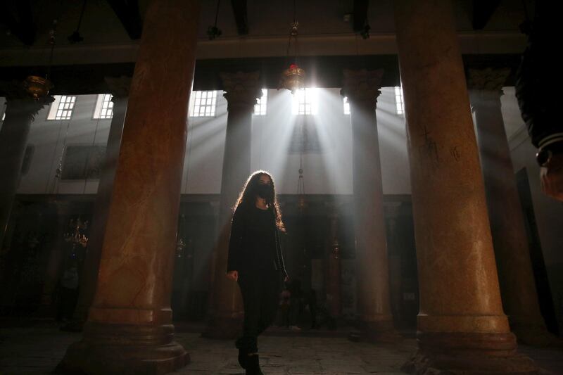 A local tourist visits the Church of Nativity ahead of the Christmas preparations in the West Bank city of Bethlehem.   EPA