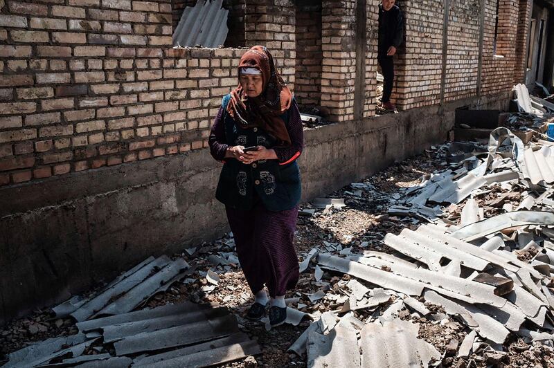 A woman stands in the ruins of her house in the village of Maksat, Kyrgyzstan, following border clashes between Kyrgyzstan and Tajikistan. A ceasefire has since been signed. AFP