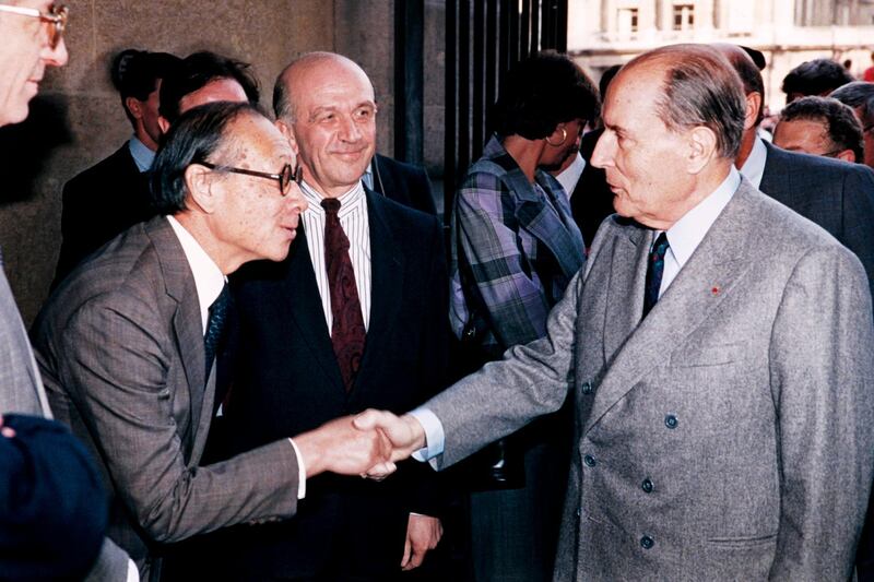 French President François Mitterrand shakes hands with Pei. AFP