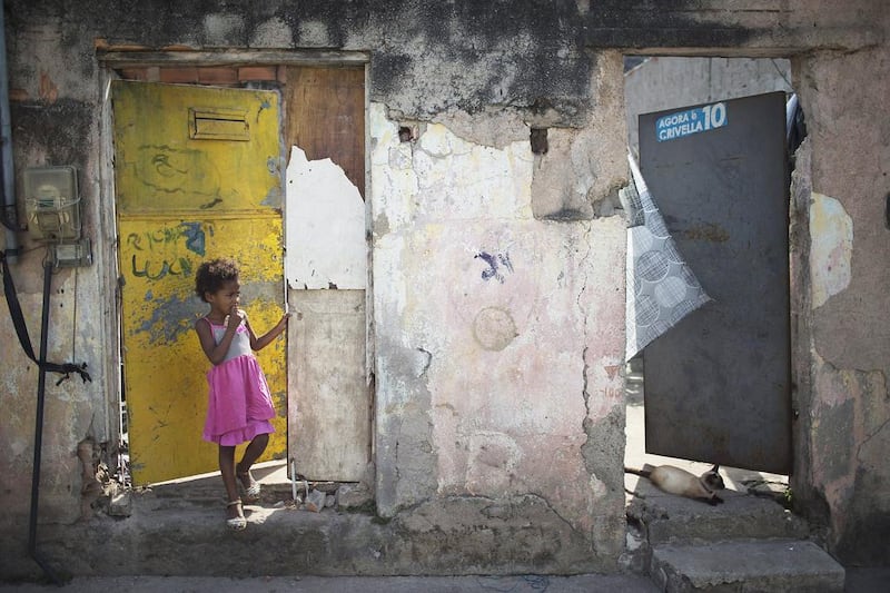 A child stands at the entrance to her house on the same street where Brazilian judo gold medalist Rafaela Silva used to live in the  Cidade de Deus slum of Rio de Janeiro, Brazil, on August 9, 2016. Leo Correa/AP Photo