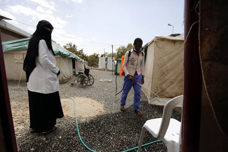 A hospital employee sprays chlorinated water outside makeshift tents amid a cholera outbreak, at a hospital in Sana'a, Yemen.  EPA