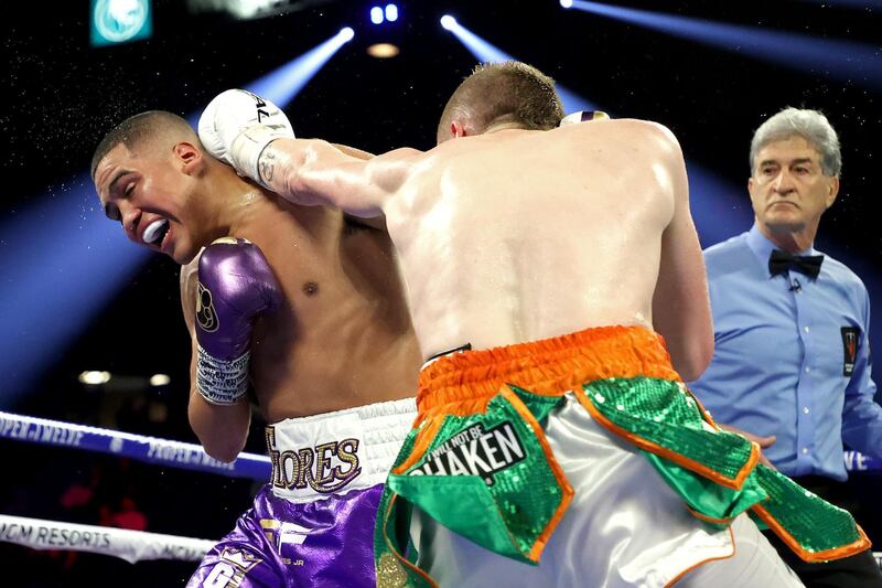 Matt Conway (L) punches Gabriel Flores Jr. during their junior lightweight bout at MGM Grand Garden Arena in Las Vegas. AFP