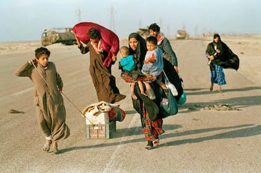 Near the northern Kuwait-Iraq border, a Kuwaiti refugee family heads towards home on March 2, 1991 after being imprisoned in Iraq for a month during the war. AP Photo