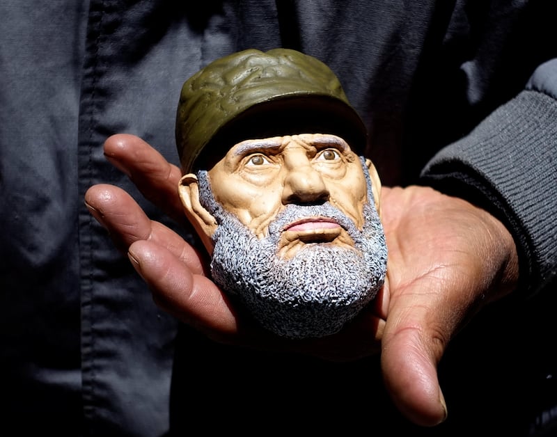 An artisan holds a mask of Cuba's late leader Fidel Castro to make 'T'antawawas' (children's bread) to commemorate the 'Day of the Dead' in La Paz, Bolivia. David Mercado / Reuters