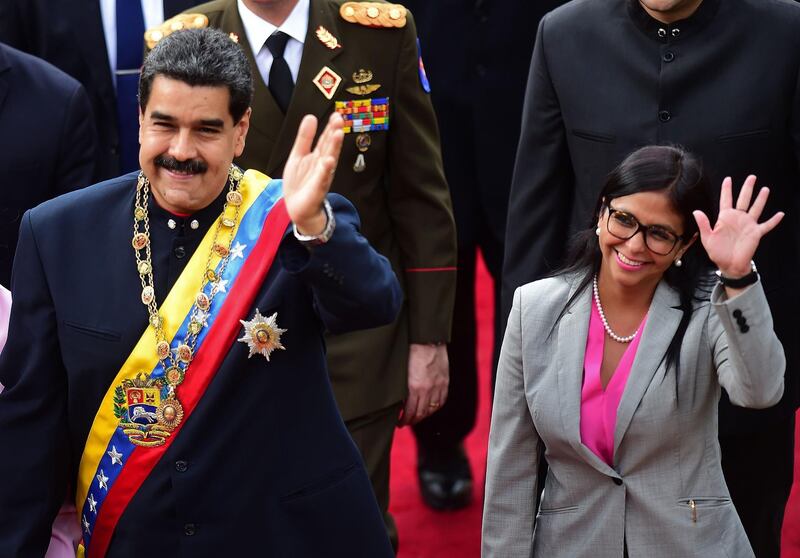 (FILES) In this file picture taken on August 10, 2017 Venezuelan President Nicolas Maduro (L) arrives at the Congress with (then) head of the Constituent Assemby, Delcy Rodriguez (R) to address the all-powerful pro-Maduro assembly which has been placed over the National Assembly and tasked with rewriting the constitution, in Caracas. Venezuelan President Nicolas Maduro announced on June 14, 2018 in his Twitter account several changes in his government, highlighting the appointment of Delcy Rodriguez, one of his closest allies, as vice-president, replacing Tareck El Aissami. / AFP / Ronaldo SCHEMIDT
