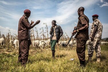 Members of a local group in Barkin Ladi, Nigeria, speaking with a young herder about ensuring that his cows do not enter farmland without the permission of farmers. Jane Hahn / The Washington Post / Getty Images