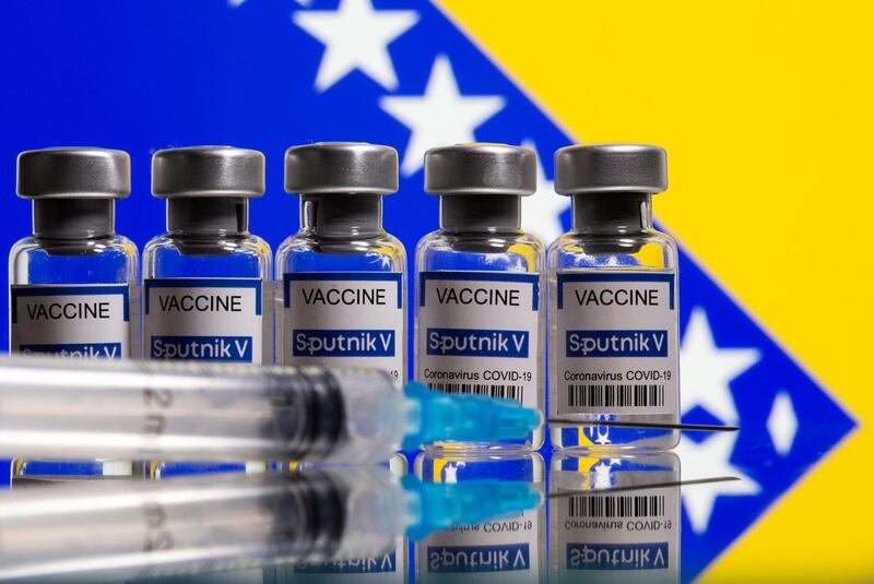 FILE PHOTO: Vials labelled "Sputnik V coronavirus disease (COVID-19) vaccine" and a syringe are seen in front of a displayed Bosnian flag in this illustration picture taken March 17, 2021. REUTERS/Dado Ruvic/Illustration//File Photo