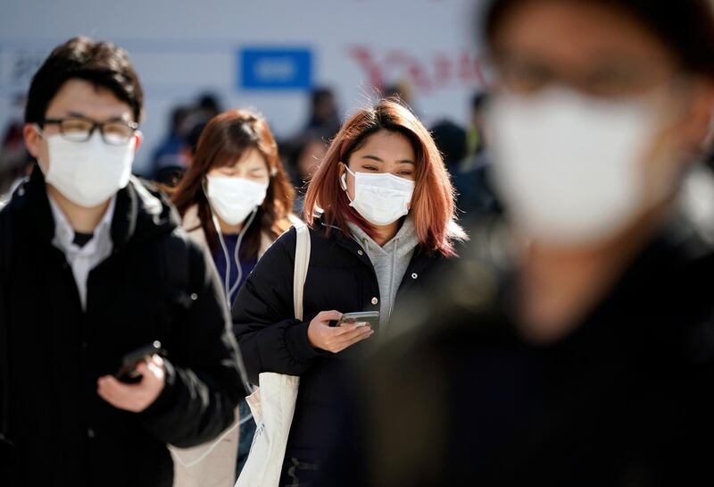 Pedestrians wearing masks cross a street in Shibuya district, Tokyo, Japan.  EPA