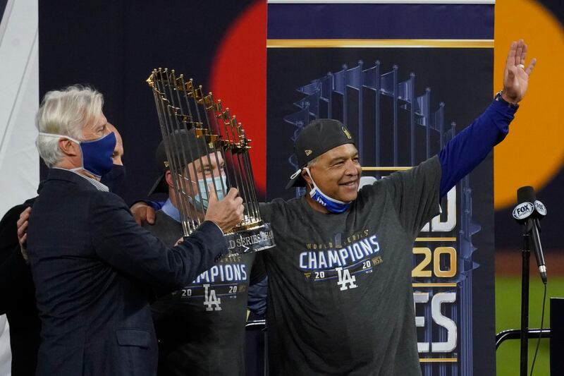 Los Angeles Dodgers manager Dave Roberts celebrates with the trophy. AP