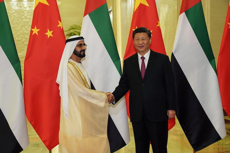 CORRECTION / United Arab Emirates Vice President and Prime Minister Sheikh Mohammed bin Rashid al Maktoum (L) shakes hands with President of the People's Republic of China Xi Jinping (R) as they meet at the Great Hall of People in Beijing on April 25, 2019. Leaders from 37 countries have been converging in Beijing for the Belt and Road Forum on April 25, hoping to grab a piece of the 1 trillion USD pie to improve their infrastructure.  / AFP / POOL / Andrea VERDELLI
