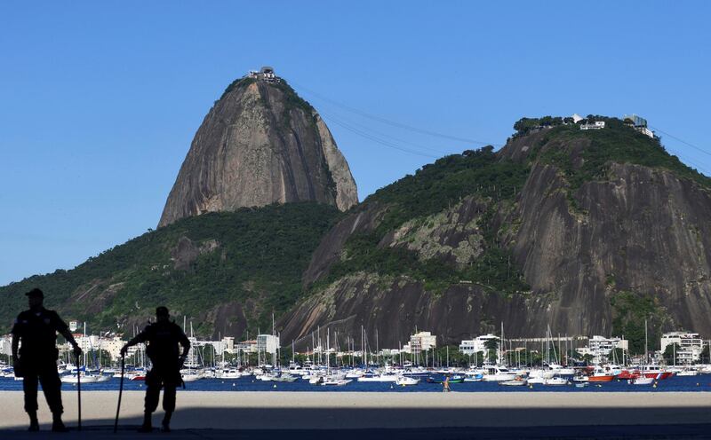 Police officers patrol the Botafogo beach following the closure of the beaches, amid the coronavirus disease (COVID-19) outbreak, in Rio de Janeiro, Brazil. REUTERS