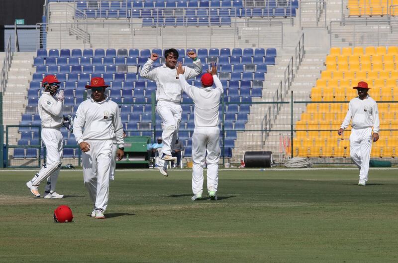 Rashid Khan, third from left, celebrates after taking his fifth wicket of the UAE’s second innings in their Intercontinental Cup match at Zayed Cricket Stadium in Abu Dhabi. Afghanistan won by 10 wickets. Courtesy Amith Passela