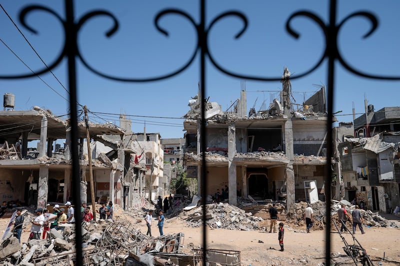 Beit Hanoun neighbours gather in a clearing strewn with debris from an air-strike before a  ceasefire that halted the 11-day war in Gaza between Hamas and Israel. AP Photo