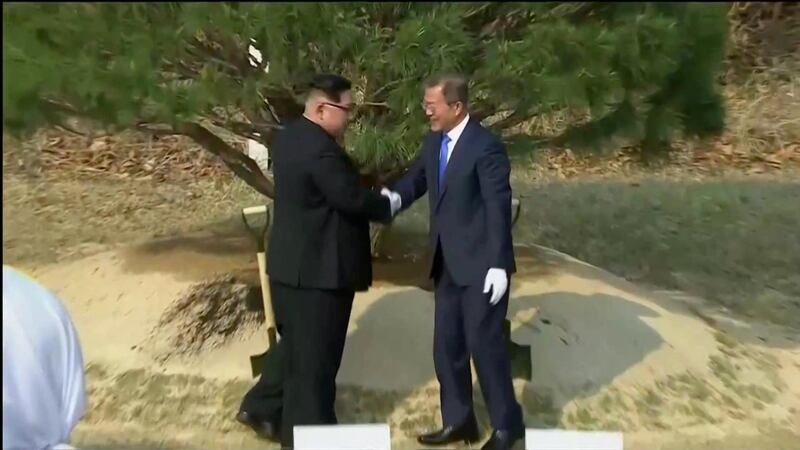 The delegations bought soil and water from the North and South to pour over the tree.