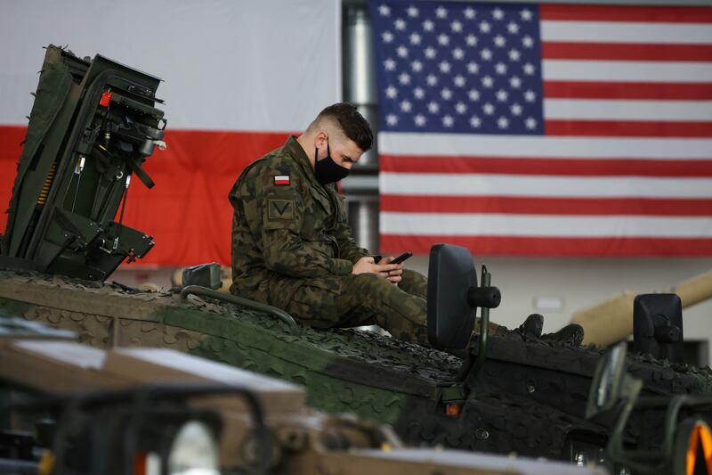 A Polish soldier uses his phone, as US  Defence Secretary Lloyd Austin and Polish Defence Minister Mariusz Blaszczak visit the Air Base in Powidz, Poland. Reuters