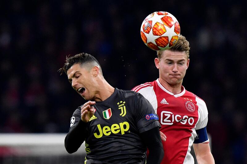 FILE - In this Wednesday, April 10, 2019 file photo, Ajax's Matthijs de Ligt, right, fights for the ball with Juventus' Cristiano Ronaldo during the Champions League quarterfinal, first leg, soccer match between Ajax and Juventus at the Johan Cruyff ArenA in Amsterdam, Netherlands. Defender Matthijs de Ligt is undergoing medical exams with Juventus ahead of an expected 70 million euros ($80 million) transfer from Ajax. Juventus shared photos and videos on social media of De Ligt's arrival in Turin late Tuesday then fans awaiting him outside the club's training facility when he showed up early Wednesday, July 17, 2019. (AP Photo/Martin Meissner, File)
