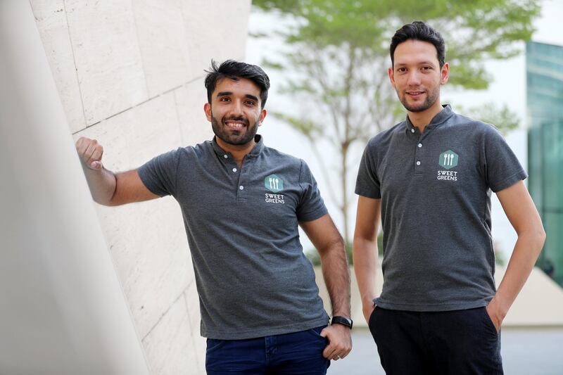 Abu Dhabi, United Arab Emirates - September 15, 2019: Owners and founders Nikhil Hemnani (L) and Ahmad Ali Abdul Hamid. A look at the newly opened Sweet Greens café. They have a special focus on being healthy and environmentally friendly. Sunday the 15th of September 2019. Rihan Heights, Abu Dhabi. Chris Whiteoak / The National