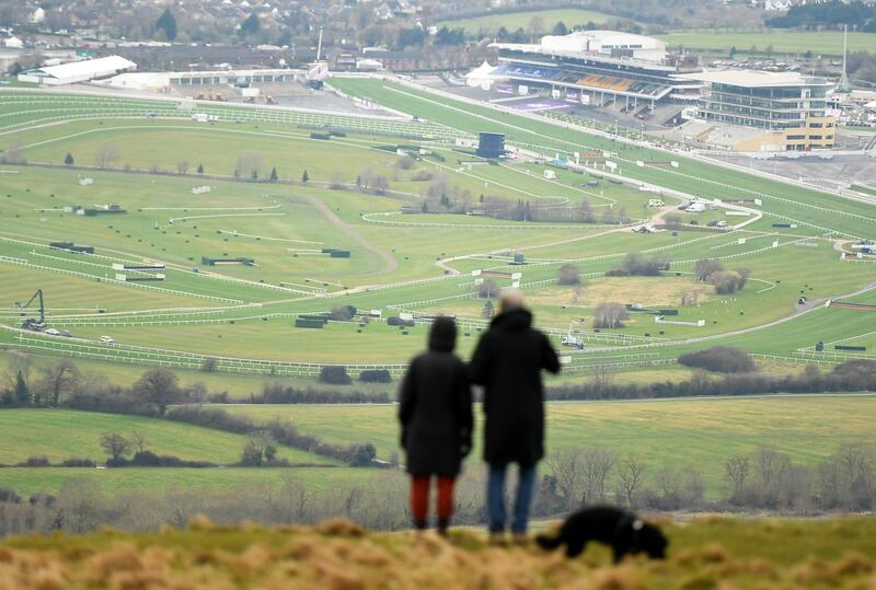 Members of the public watch from Cleeve Hill overlooking the Cheltenham Festival on Friday, March 19. Getty