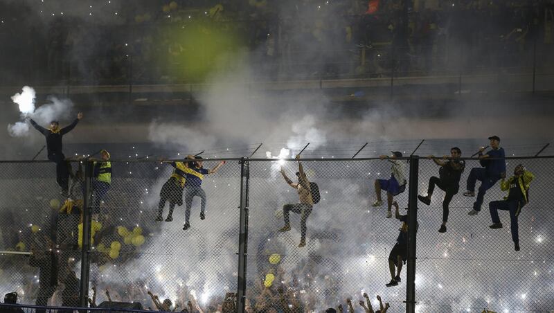 Fans of Boca Juniors climb the fence after winning the Argentina Superliga 2017/18 at La Bombonera.  Agustin Marcarian / Getty Images