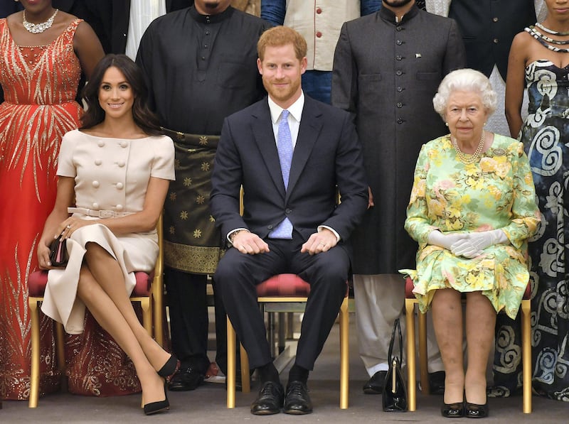 LONDON, ENGLAND - JUNE 26: Meghan, Duchess of Sussex, Prince Harry, Duke of Sussex and Queen Elizabeth II at the Queen's Young Leaders Awards Ceremony at Buckingham Palace on June 26, 2018 in London, England. The Queen's Young Leaders Programme, now in its fourth and final year, celebrates the achievements of young people from across the Commonwealth working to improve the lives of people across a diverse range of issues including supporting people living with mental health problems, access to education, promoting gender equality, food scarcity and climate change.  (Photo by John Stillwell - WPA Pool/Getty Images)