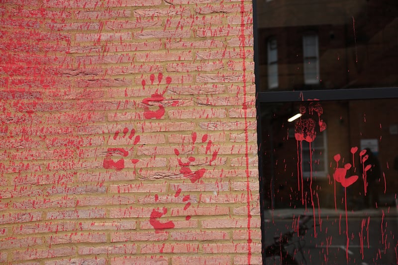 Red handprints on the side of the building. Reuters