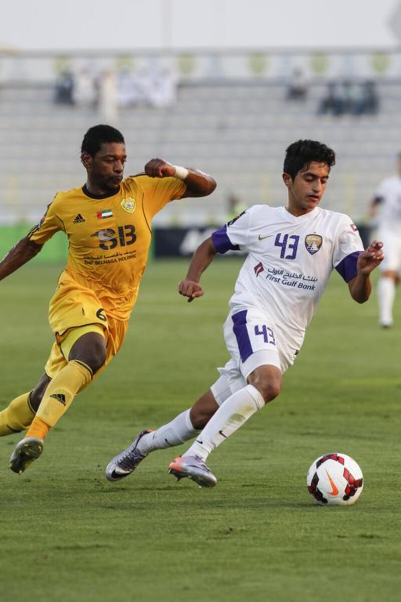 Al Ain's Ryan Mohamad, right, turns away from Ganim Ahmed Basheer during their Arabian Gulf League match in Dubai on May 9, 2014. Antonie Robertson / The National