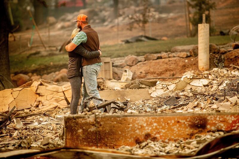 Chris and Nancy Brown embrace while searching through the remains of their home, leveled by the Camp Fire, in Paradise. AP Photo