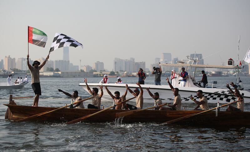 Members of Al Asifa boat team celebrate after winning the Dubai Traditional Rowing (30-foot) Race local class. All photos: EPA