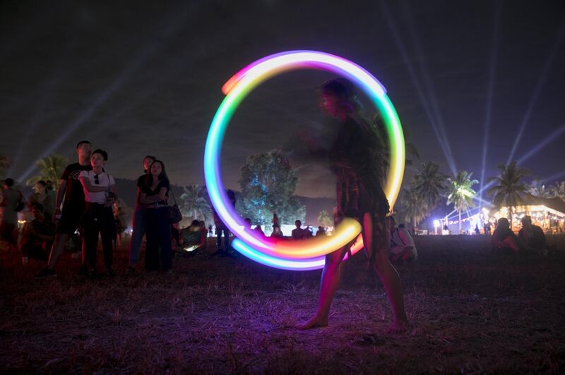 A woman performs a light show during Wonderfruit 2018 in Pattaya, Thailand. Getty Images