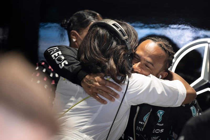 Former US First Lady Michelle Obama hugs Lewis Hamilton at the Miami Grand Prix in Florida. AFP