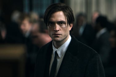 This image released by Warner Bros.  Pictures shows Robert Pattinson in "The Batman. " Warner Bros.  released the first trailer for “The Batman,” which is Pattinson’s first film as the Dark Knight.  It will be released March 4, 2022.  (Warner Bros.  Pictures via AP)