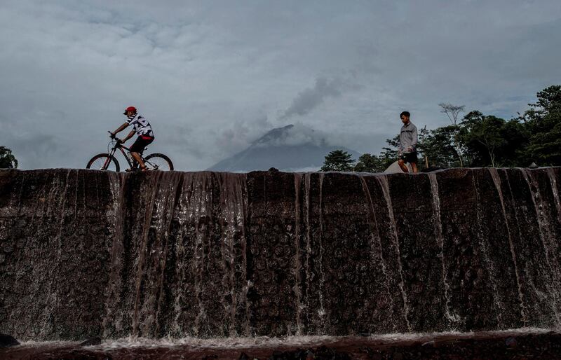 Villagers pass by Mount Semeru in Lumajang, East Java. AFP