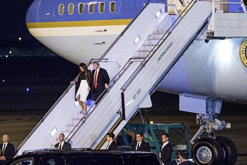 U.S. President Donald Trump, right, and U.S. First Lady Melania Trump disembark from Air Force One after arriving at Ezeiza Airport ahead of the G-20 Leaders' Summit in Buenos Aires, Argentina, on Thursday, Nov. 29, 2018. This weekend's G-20 summit in Buenos Aires matters less for the main proceedings than for President Trump's expected encounter with Chinese President Xi Jinping. Photographer: Sarah Pabst/Bloomberg