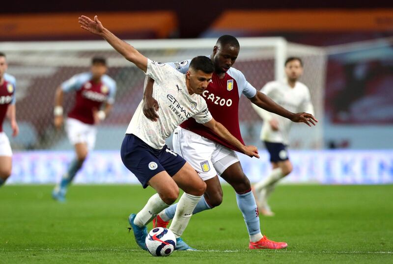 BIRMINGHAM, ENGLAND - APRIL 21: Rodrigo of Manchester City and Keinan Davis of Aston Villa battle for the ball during the Premier League match between Aston Villa and Manchester City at Villa Park on April 21, 2021 in Birmingham, England. Sporting stadiums around the UK remain under strict restrictions due to the Coronavirus Pandemic as Government social distancing laws prohibit fans inside venues resulting in games being played behind closed doors. (Photo by Chloe Knott - Danehouse/Getty Images)