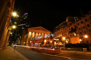 An empty bus is driven through the quiet streets outside the Bank of England in the early hours, as lockdown continues in London. Reuters