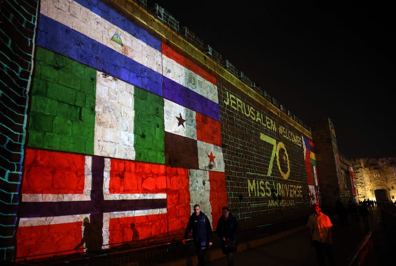 Flags of different countries are projected on the walls of Jerusalem's Old City. AFP