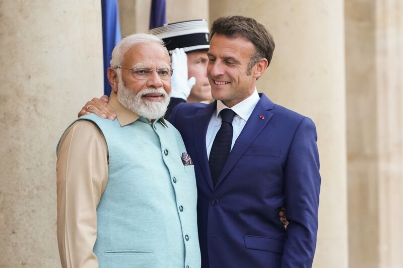 Mr Macron greets Mr Modi at the Elysee Palace in Paris. Bloomberg