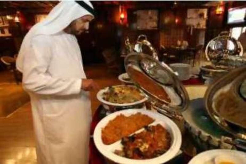 November 27, 2008 / Dubai / Mr Abdullah Harib runs AL Boom Tourist Village in a prime landmark in Dubai, where people can go for authentic emirate food and culture. (Sammy Dallal / The National) 


 *** Local Caption ***  sd-112108-food06.jpg