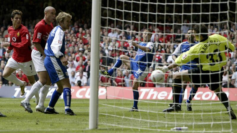 Manchester United's Cristiano Ronaldo (L) of Portugal watches as his header goes in for a goal as Millwall's player-manager Dennis Wise (3R) and goalkepper Andy Marshall (R) watch during the FA Cup final at the Millennium Stadium in Cardiff, May 22, 2004. NO ONLINE/INTERNET USE WITHOUT A LICENCE FROM THE FOOTBALL DATA CO LTD. FOR LICENCE ENQUIRIES PLEASE TELEPHONE +44 207 298 1656 REUTERS/Simon Bellis REUTERS  MD/THI