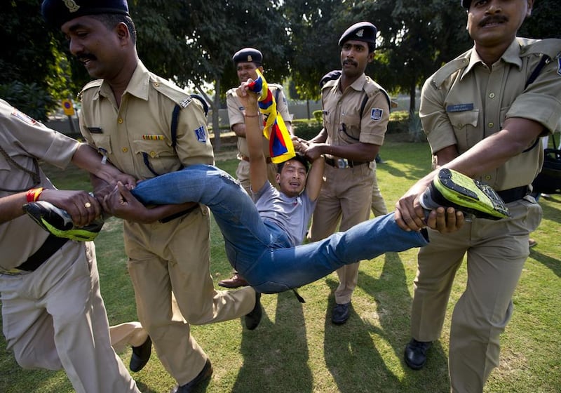 Policemen detain a Tibetan exile shouting anti China slogans outside the Chinese embassy to mark the 57th anniversary of the March 10, 1959, Tibetan Uprising Day, in New Delhi.  Saurabh Das / AP Photo