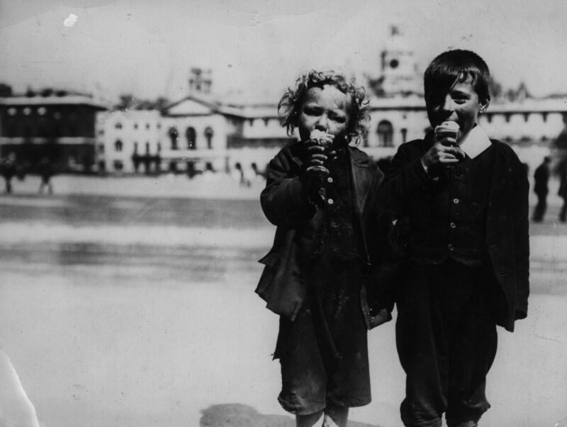 Children enjoy their ice creams during a heatwave in 1914, outside Horse Guards Parade in London.