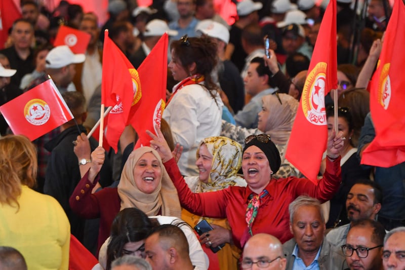 Audience members wave flags during a Labour Day celebration organised by the Tunisian General Labour Union in Tunis. AFP