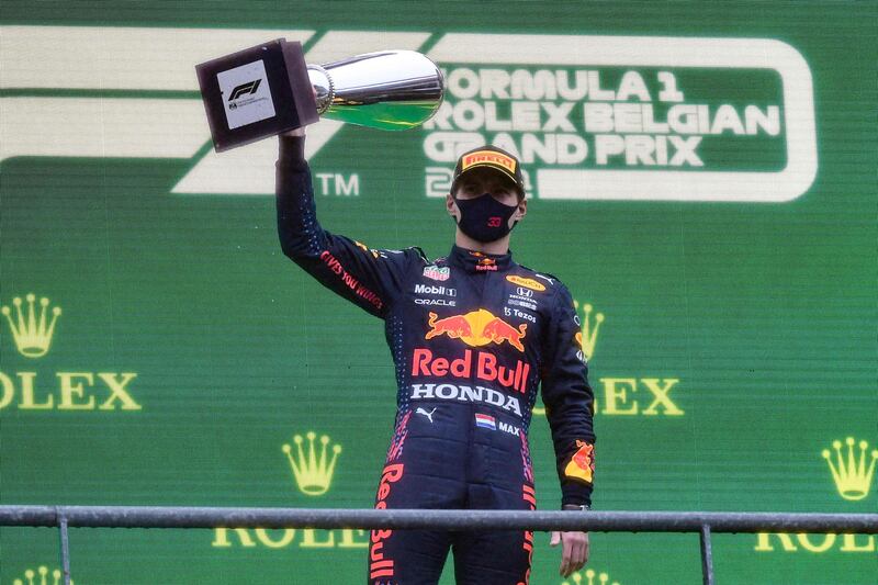 Red Bull's Max Verstappen celebrates  on the podium after taking first place in the rain-ravaged Belgian Grand Prix at the Spa-Francorchamps circuit on Sunday, August 29. AFP