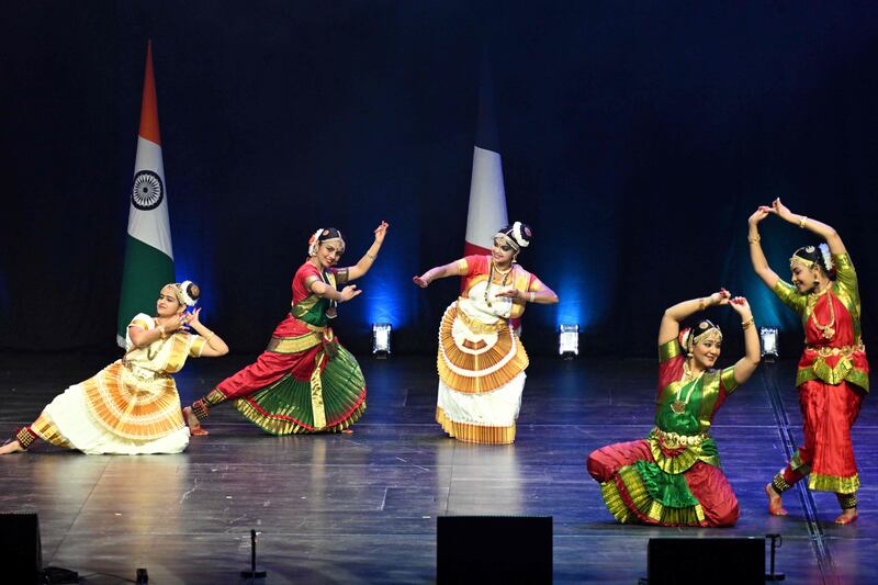 Dancers perform before a speech by Mr Modi at La Seine Musicale complex. AFP