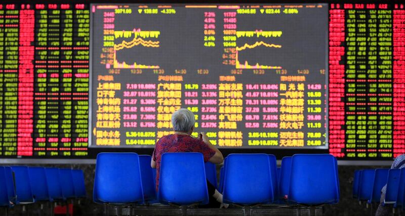 An investor looks at an electronic board showing stock information at a brokerage house in Shanghai, August 25, 2015. China's major stock indexes sank more than 6 percent in early trade on Tuesday, after a catastrophic Monday that saw Chinese exchanges suffer their biggest losses since the global financial crisis, destabilizing financial markets around the world. REUTERS/Aly Song      TPX IMAGES OF THE DAY