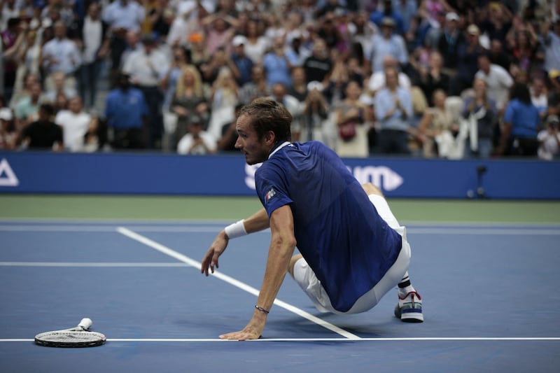 Russia's Daniil Medvedev drops to the ground in celebration. AFP