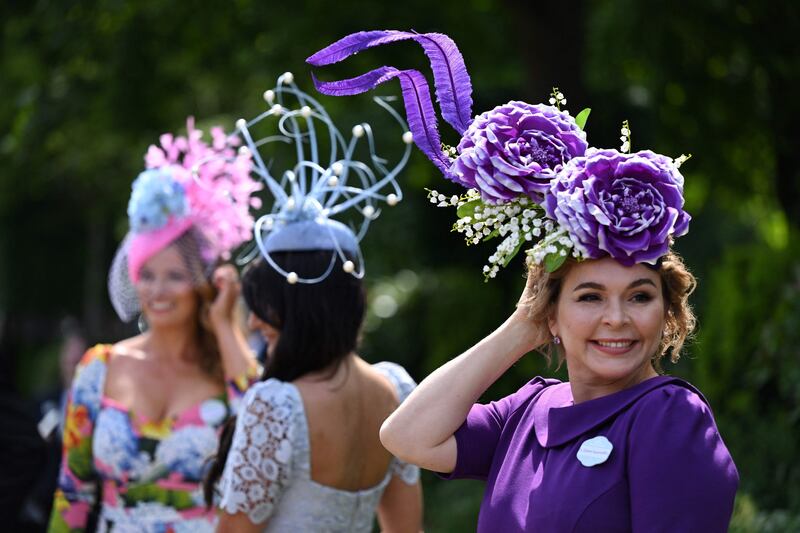 A fabulous purple hat adds drama to a matching outfit. AFP