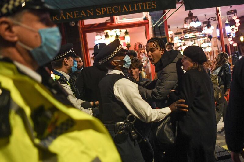 Police officers move crowds in Soho. Getty Images