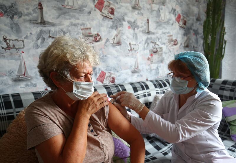 Vera Kuznetsova receives a vaccine dose at home in the village of Loznoye in Volgograd, Russia. Reuters